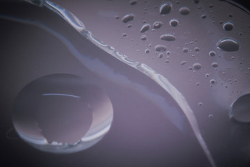 Macro shots cooking oil mixed with water on the glass surface 