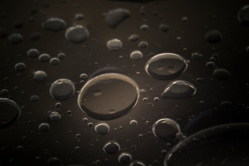 Macro shots cooking oil mixed with water on the glass surface 