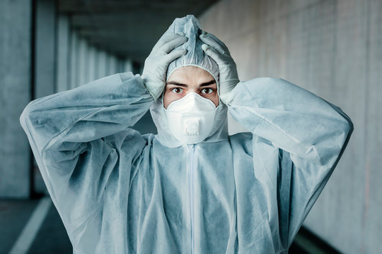 Portrait of despaired man wearing protective clothing