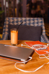 Workplace essentials. working from anywhere. orange juice and laptop