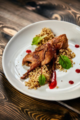 A plate of quinoa quail on a table