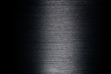 Texture of black anodized brushed aluminum with light reflection in the center - obrazy, fototapety, plakaty