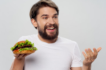 Cheerful male fast food hamburger in diet close-up