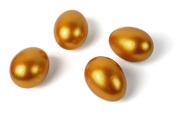 Four Easter golden eggs on a white background