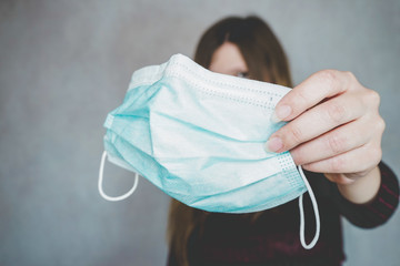 Someone holding a traditional med face mask