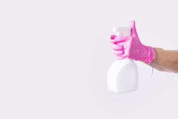 Hand in latex pink medical protection gloves white antibacterial sanitizer. Coronavirus optimistic hygiene concept. Copy space