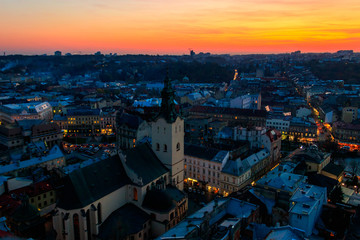 Naklejka premium Aerial view of Latin cathedral and Rynok square in Lviv, Ukraine at sunset. View from Lviv town hall