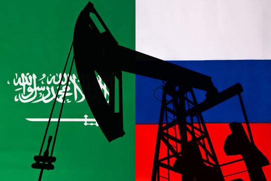 Business dialogue, oil agreement concept : National flags of Russia and Saudi Arabia on a table. A symbol of cooperation between Moscow Kremlin and Riyadh, an Islamic state. War over oil prices.