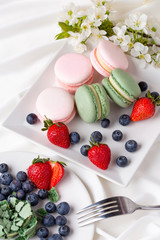 Macaroon pink and mint delicious with blueberries and strawberries and tea