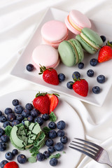 Macaroon pink and mint delicious with blueberries and strawberries and tea