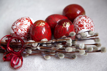 Easter eggs on a white background with a willow branch