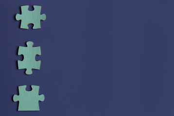 Three puzzle pieces on blue background.copyspace for text.