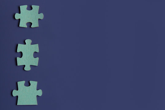 Three puzzle pieces on blue background.copyspace for text.
