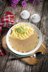 Pure white borscht served with mashed potatoes.
