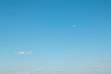 It is getting party. Blue sky. Moon. The young moon. Transparent moon.