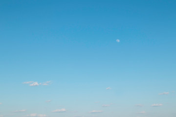 It is getting party. Blue sky. Moon. The young moon. Transparent moon.