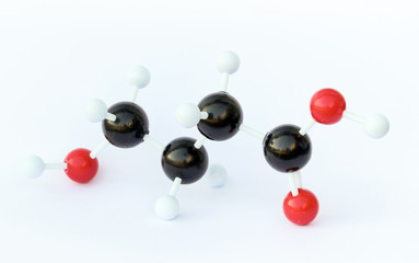 Plastic ball-and-stick model of a gamma-Hydroxybutyric acid (GHB) molecule against a white background. GHB is a neurotransmitter, a psychoactive drug an known as a date rape drug.