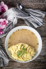 Pure white borscht served with mashed potatoes.