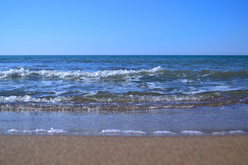 Tropical sandy beach with waves on a Sunny summer day. copy space.