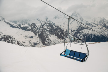 ski chair lift ropeway at the ski resort, view from the funicular to the mountains