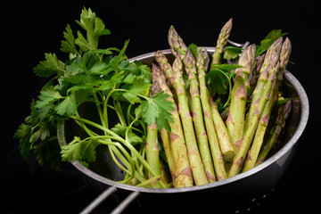 green asparagus cut on black background