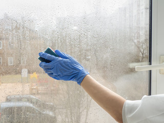 Coronavirus disinfection. People in making disinfection on windows