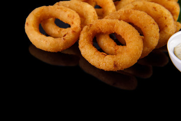 onion rings on a black background for a restaurant menu