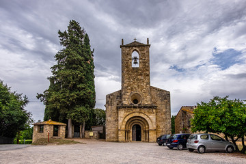 Fototapeta na wymiar Santa Maria de Porqueres romanic church in Lake of Banyoles, Catalonia, Spain.