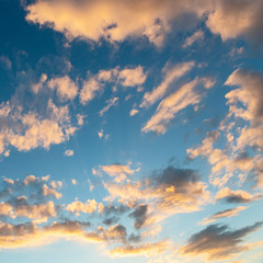 evening sky with clouds beautifully illuminated by the setting sun as a natural background
