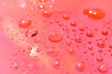 shiny clear water point attached to a glass reflects the same color as the color on the glass into a beautiful background as decoration