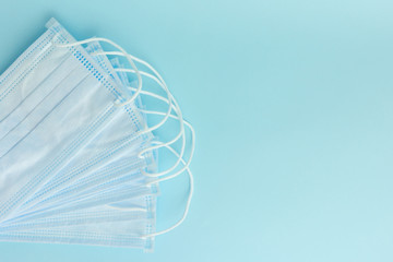 new surgical masks for coronavirus prevention on a blue background. Healthcare concept. Medical tools.