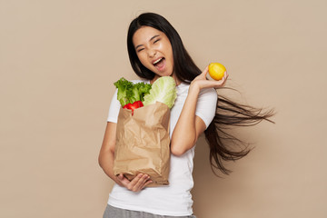 young woman holding a grocery bag