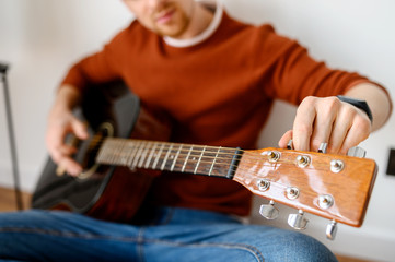 Close-up of an acoustic guitar in hands