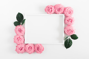 Beautiful flowers composition. Frame made of pink flowers on white background. Pink rose pattern....