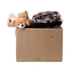 large brown cardboard box filled with things and children's toys,  concept of moving