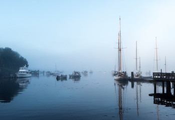 Boats Anchored In Foggy Harbor