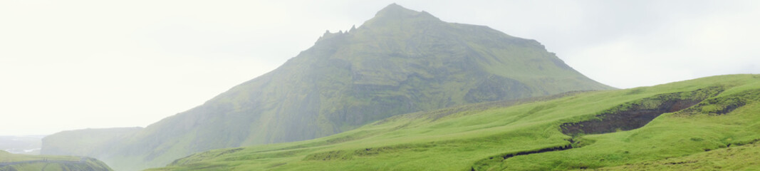 Naklejka premium Green mountains and fields of Iceland