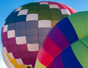 Colorful hot air balloons prepare to rise