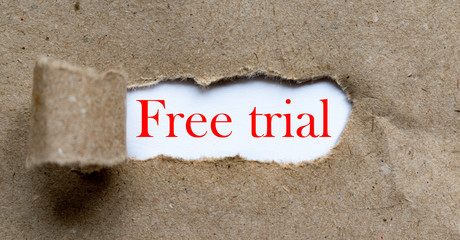 Free trial - red colour phrase on brown torn paper. Business content.