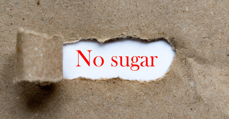 No sugar - red colour phrase on brown torn paper. Food, medicine, healthcare content.