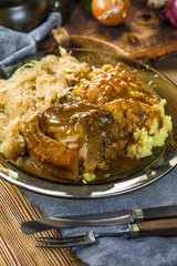 Fried ribs in sauerkraut served with boiled potatoes.