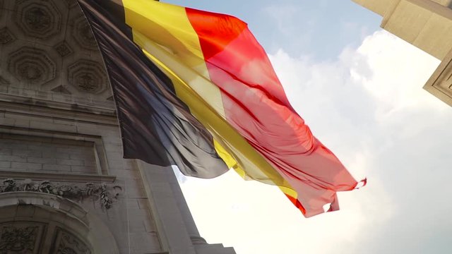 Belgium flag against tricolour stripes waving on wind from Arcade du Cinquantenaire 1920X1080 HD footage (1080p 100fps FullHD video)