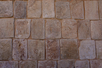 historic stone wall carved and laid by the Mayans in construction of temples 
