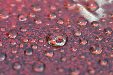shiny clear water point attached to a glass reflects the same color as the color on the glass into a beautiful background as decoration