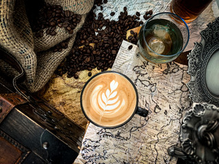 Old map nad coffe with latte art
