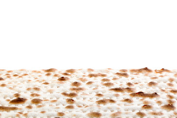 Matzah. Jewish traditional Passover bread. Pesach celebration symbol. Isolated on white. With some free space for your text or sign . Close-up.
