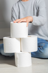 Boy plays with toilet paper, using it as a blocks
