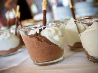 chocolate mousse dessert with whipped cream on a table at a gathering