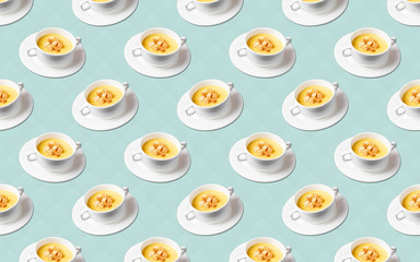 plate of pumpkin soup puree on a saucer blue background pattern