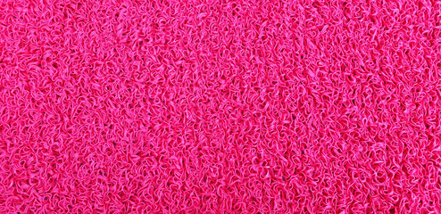 Red, rubber coating on the floor or ground.Texture.